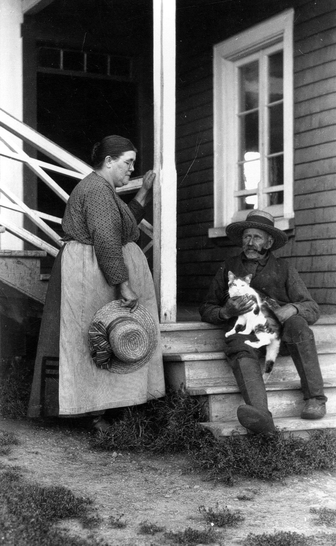 Marie Pelletier et Uldéric Dumont en habits du quotidien et conversant devant leur maison.